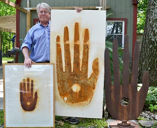 Brian Kirk with two prints and a steel sculpture.