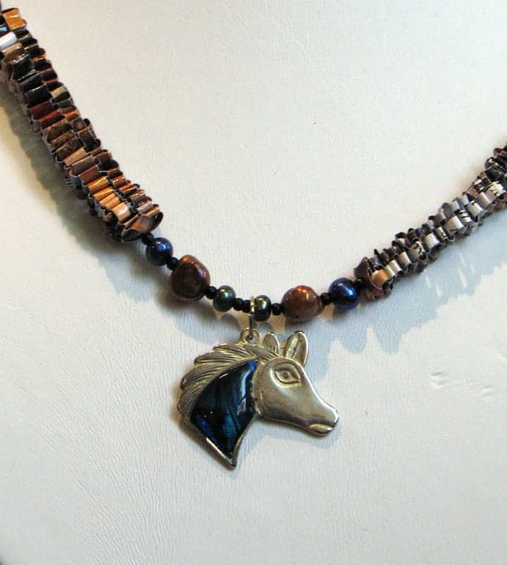 This necklace by Jessica Hensley, The Last Two Notes of a Country Song, is made with magazine paper and freshwater pearls.