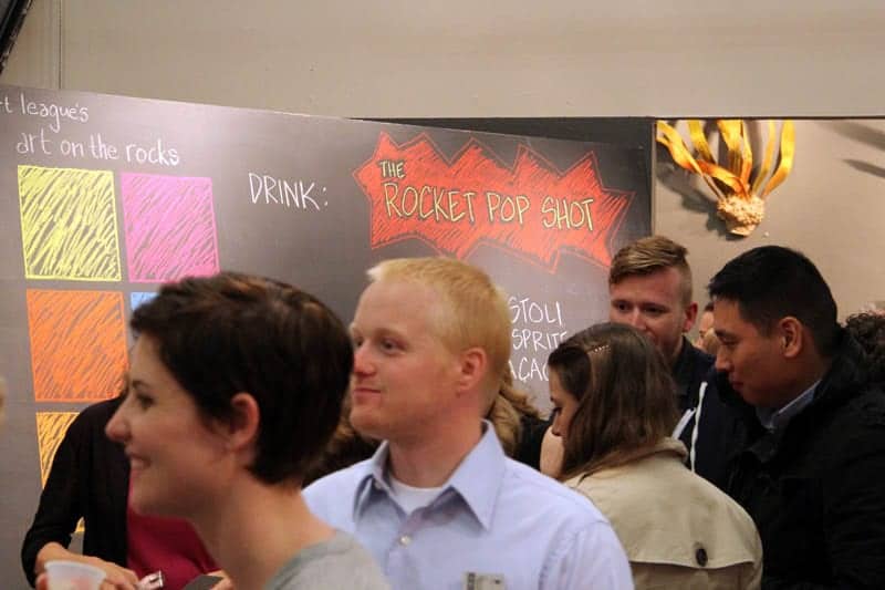 Eventgoers watch Brodie from Union Street Public House making the red, white, and blue Rocket Pop Shot.