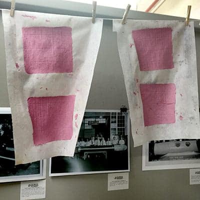 Finished squares of handmade paper air-drying. The paper lightens in color as it dries.