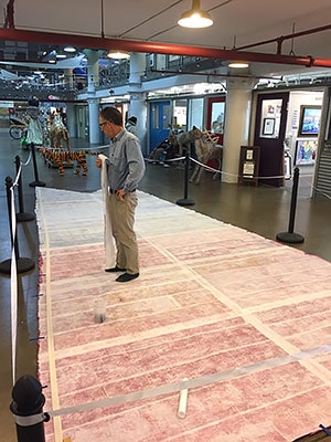 Artist Andy Yoder putting the final touches on the Highest Honor banner (see below)