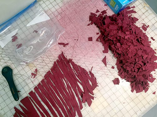 Before it can be made into pulp, the fabric must be cut into bits.