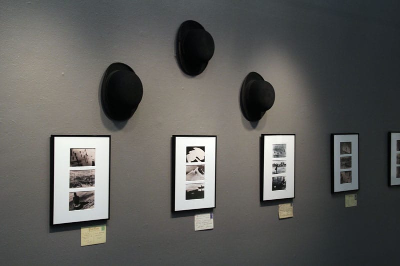 Three hats accompanying the exhibit.