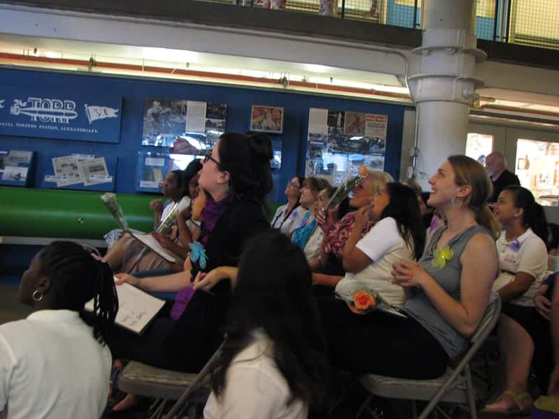 The girls and their mentors watching the video.