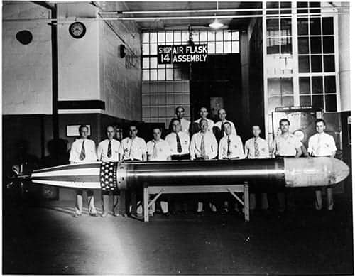 Department heads posing with the last torpedo manufactured here, in 1945. (Photo from the collection of George L. Dant, copyright the Naval History and Heritage Command.)